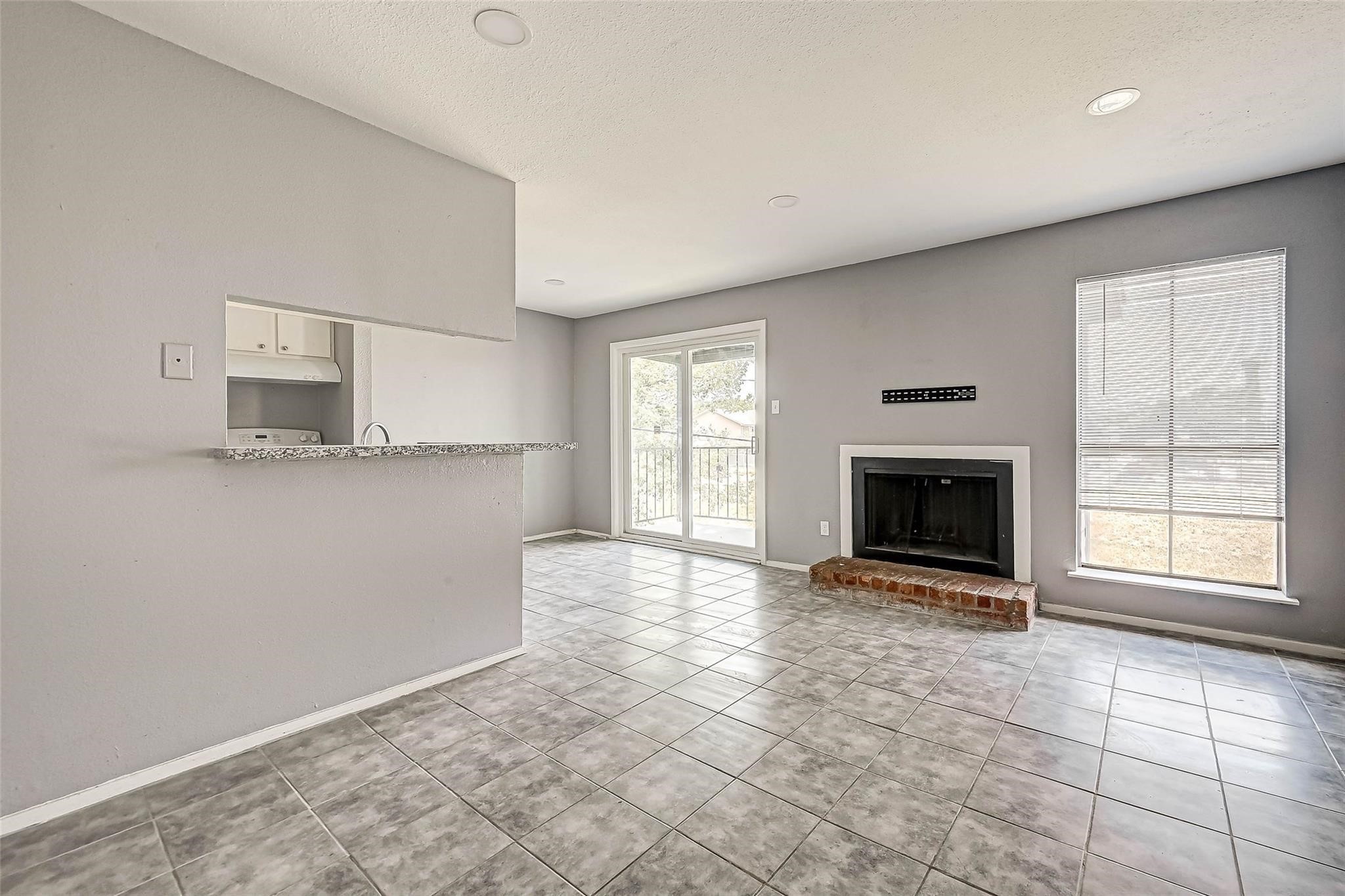 13480 South Thorntree Drive, Unit 508 Houston, TX 77015 - Photo 2 of 10 a view of empty room with a fireplace and window