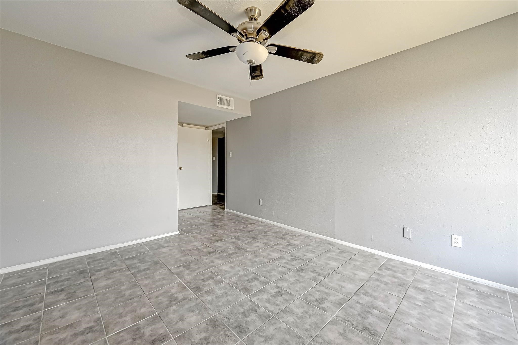 13480 South Thorntree Drive, Unit 508 Houston, TX 77015 - Photo 7 of 10 an empty room with a ceiling fan and carpet