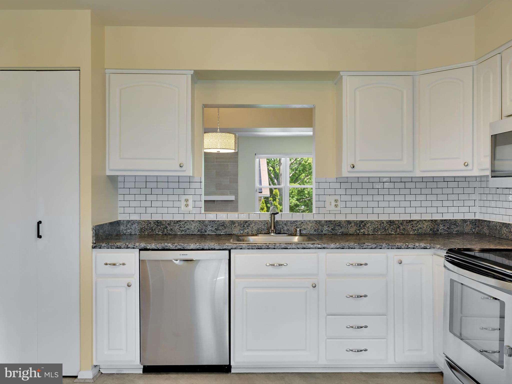 2846 Schoolhouse Circle Silver Spring, MD 20902 - Photo 11 of 32 a kitchen with granite countertop white cabinets and sink