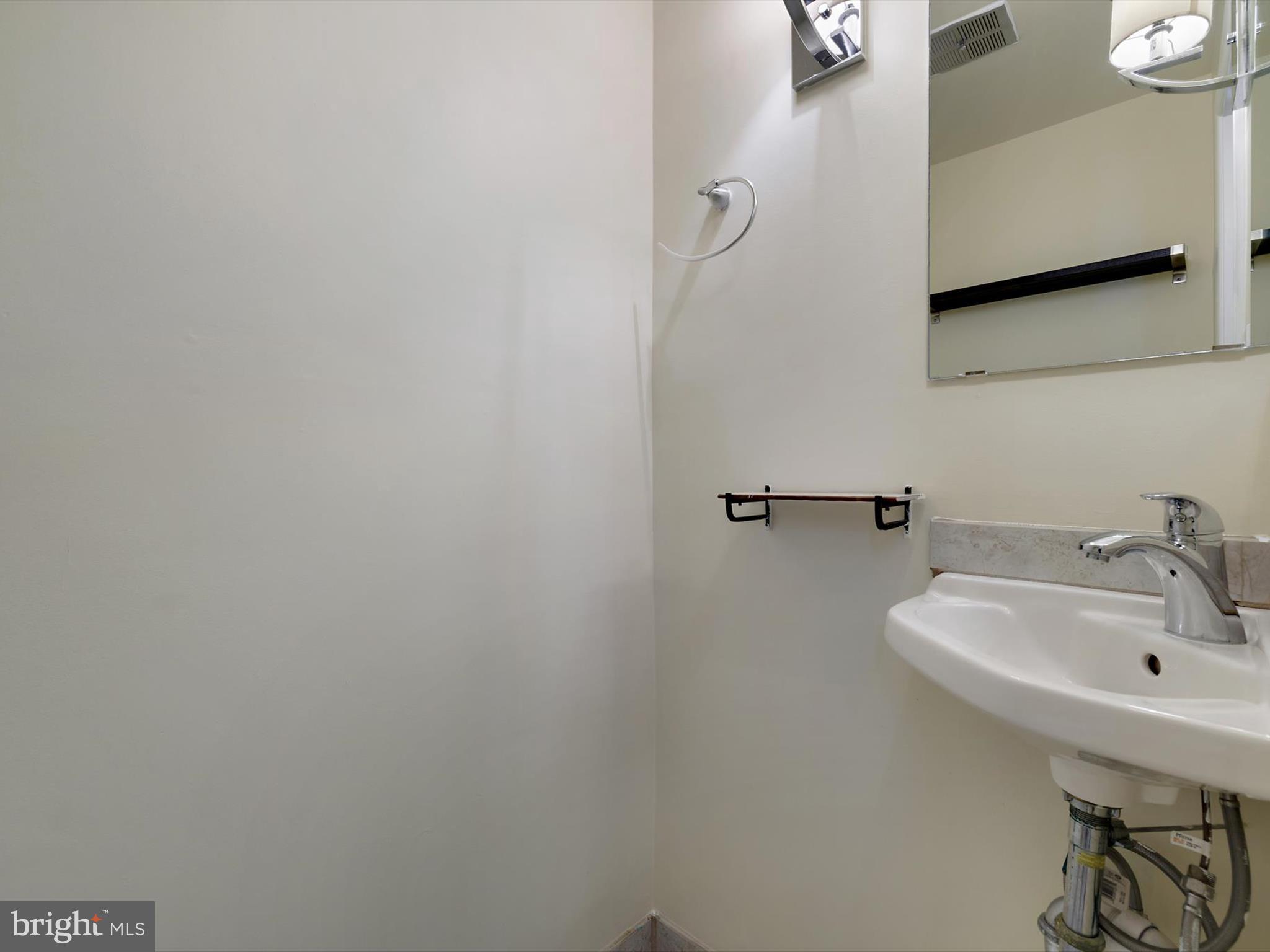 2846 Schoolhouse Circle Silver Spring, MD 20902 - Photo 14 of 32 a bathroom with a sink and mirror