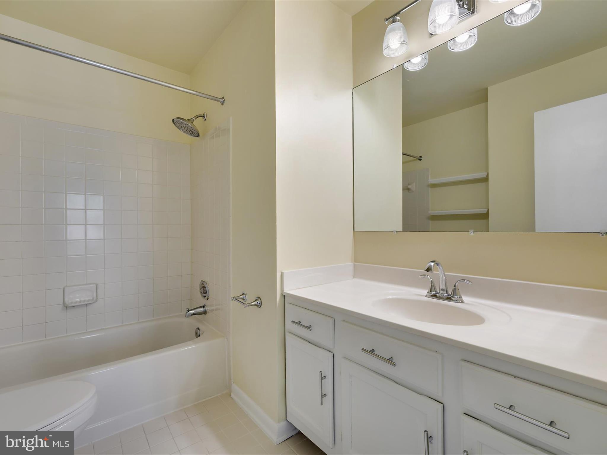2846 Schoolhouse Circle Silver Spring, MD 20902 - Photo 19 of 32 a bathroom with a tub a sink double vanity and a mirror