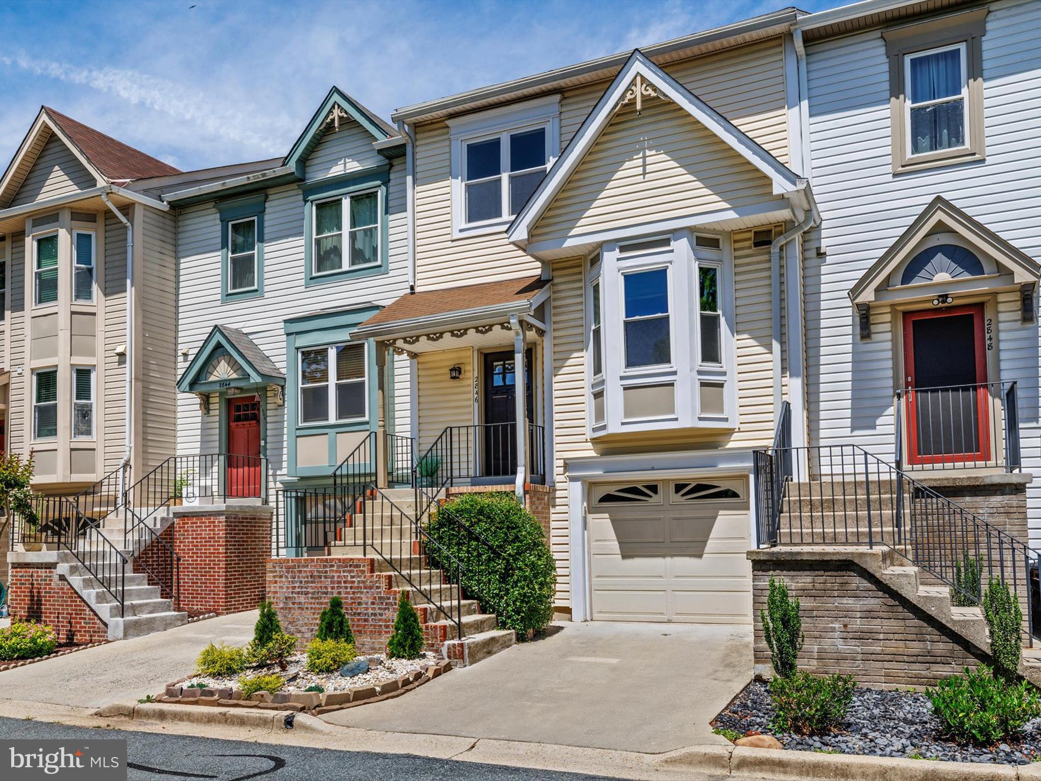 2846 Schoolhouse Circle Silver Spring, MD 20902 - Photo 2 of 32 a front view of a house with a yard