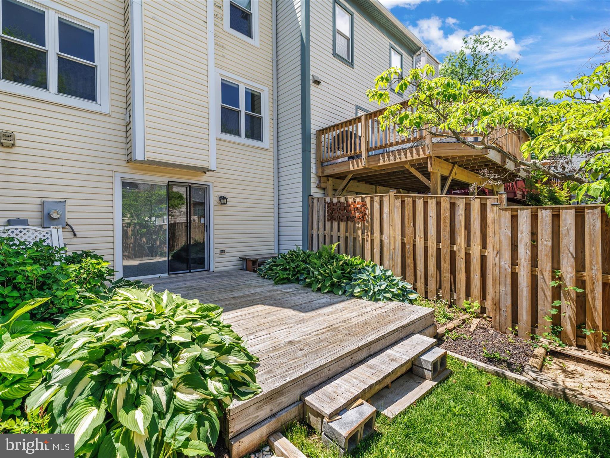 2846 Schoolhouse Circle Silver Spring, MD 20902 - Photo 30 of 32 a view of a house with a small yard and flower plants