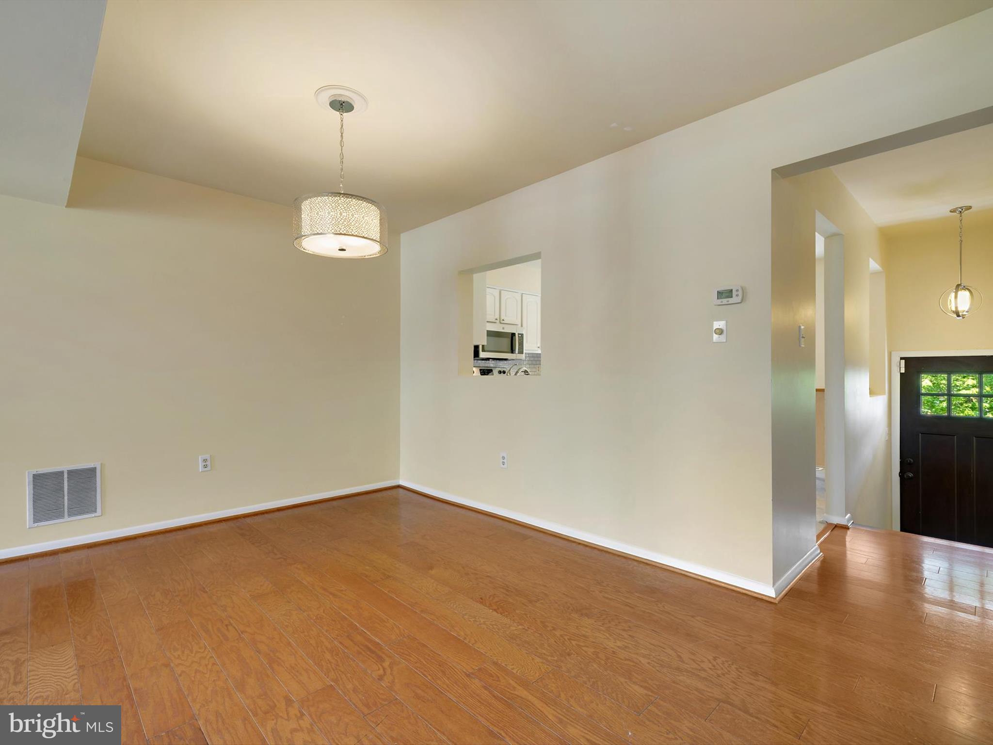 2846 Schoolhouse Circle Silver Spring, MD 20902 - Photo 5 of 32 an empty room with a chandelier fan and windows