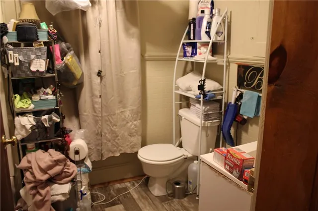 a bedroom with a bed and a night stand