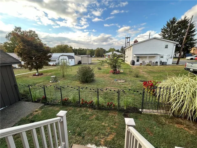 a view of a garden with wooden fence