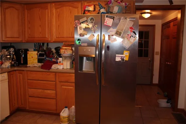 a kitchen with cabinets and a refrigerator