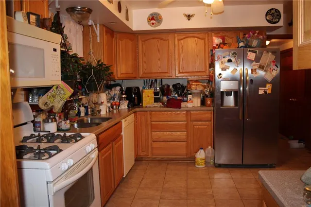 a kitchen with stainless steel appliances granite countertop a stove and a refrigerator
