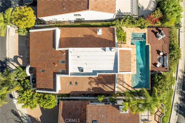 a view of a house with a window and flower plants