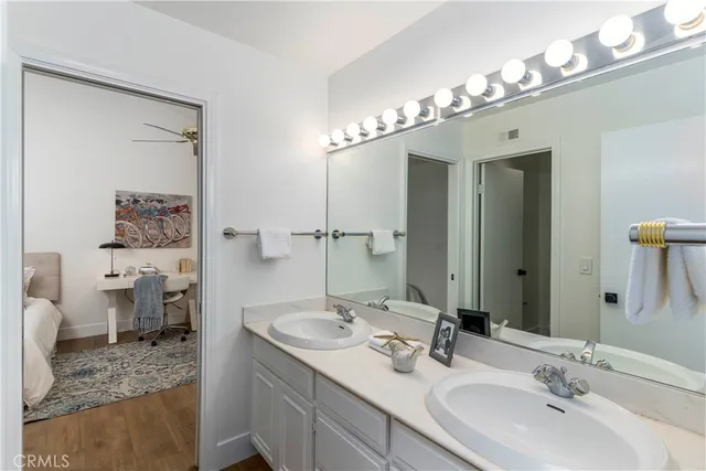 a bathroom with a sink double vanity and a mirror