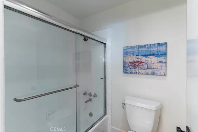 a bathroom with a shower and a toilet