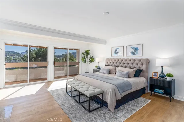 a spacious bedroom with a bed and a large window