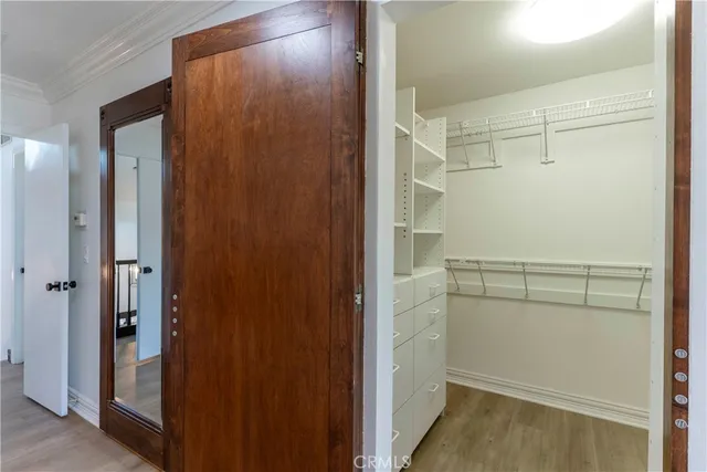 a view of walk in closet with empty racks