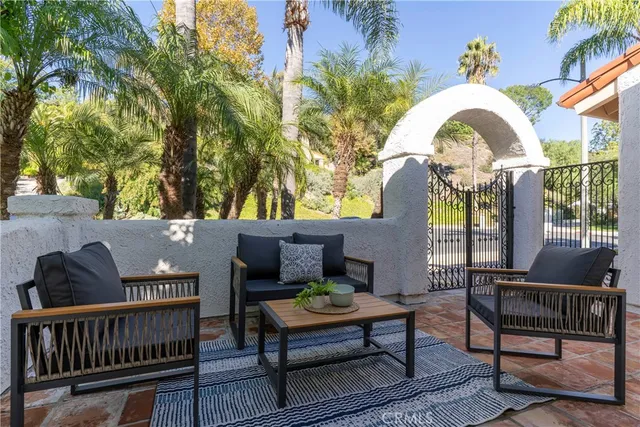 a view of a roof deck with furniture