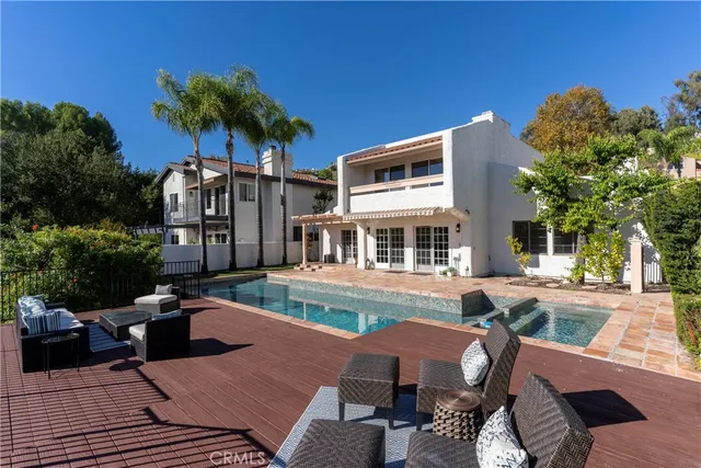 a front view of a house with garden and patio