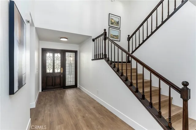 a view of an entryway with wooden floor