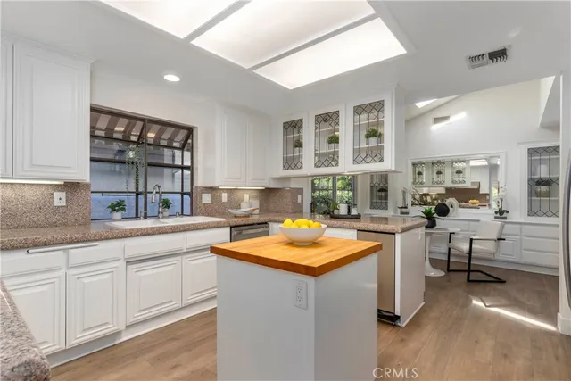 a kitchen with cabinets a sink and appliances