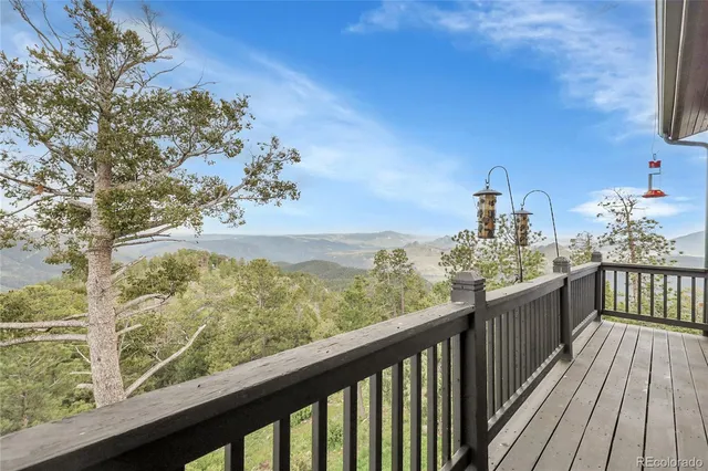a view of a balcony with wooden floor and fence