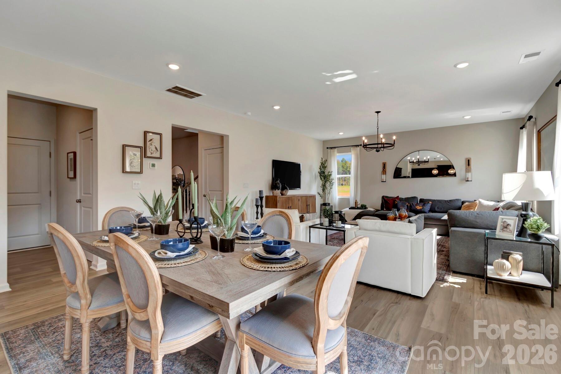 1458 Kate Cecil Way York, SC 29745 - Photo 13 of 40 a dining room with wooden floor and furniture