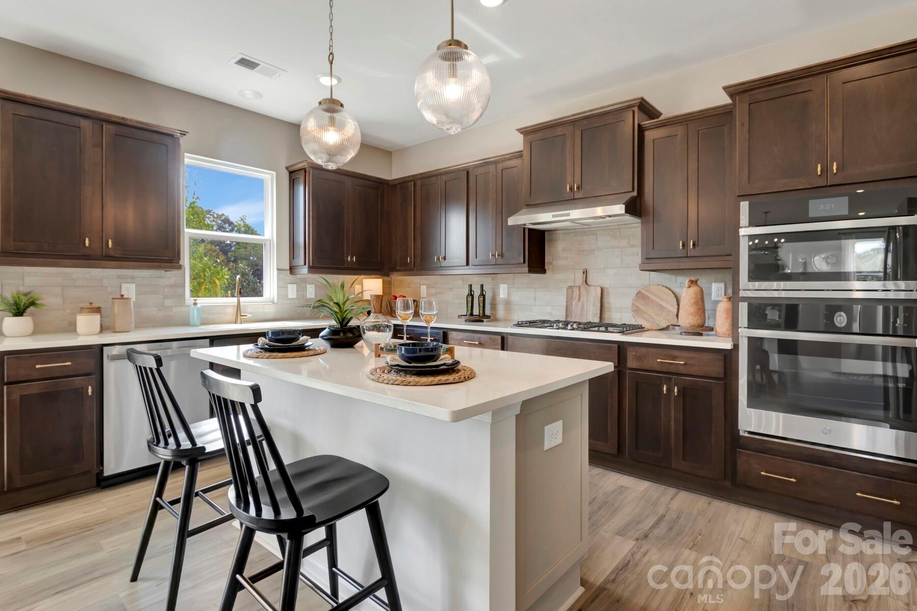1458 Kate Cecil Way York, SC 29745 - Photo 17 of 40 a kitchen with a stove a sink and cabinets