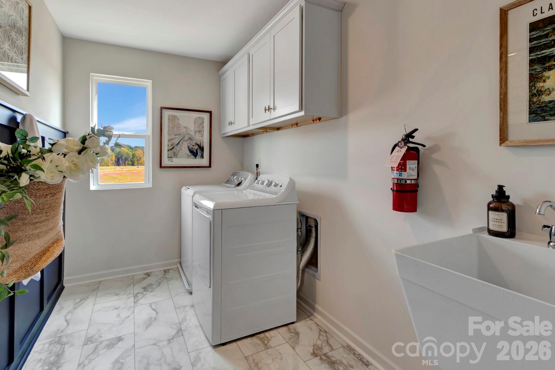 1458 Kate Cecil Way York, SC 29745 - Photo 25 of 40 a utility room with cabinets washer and dryer