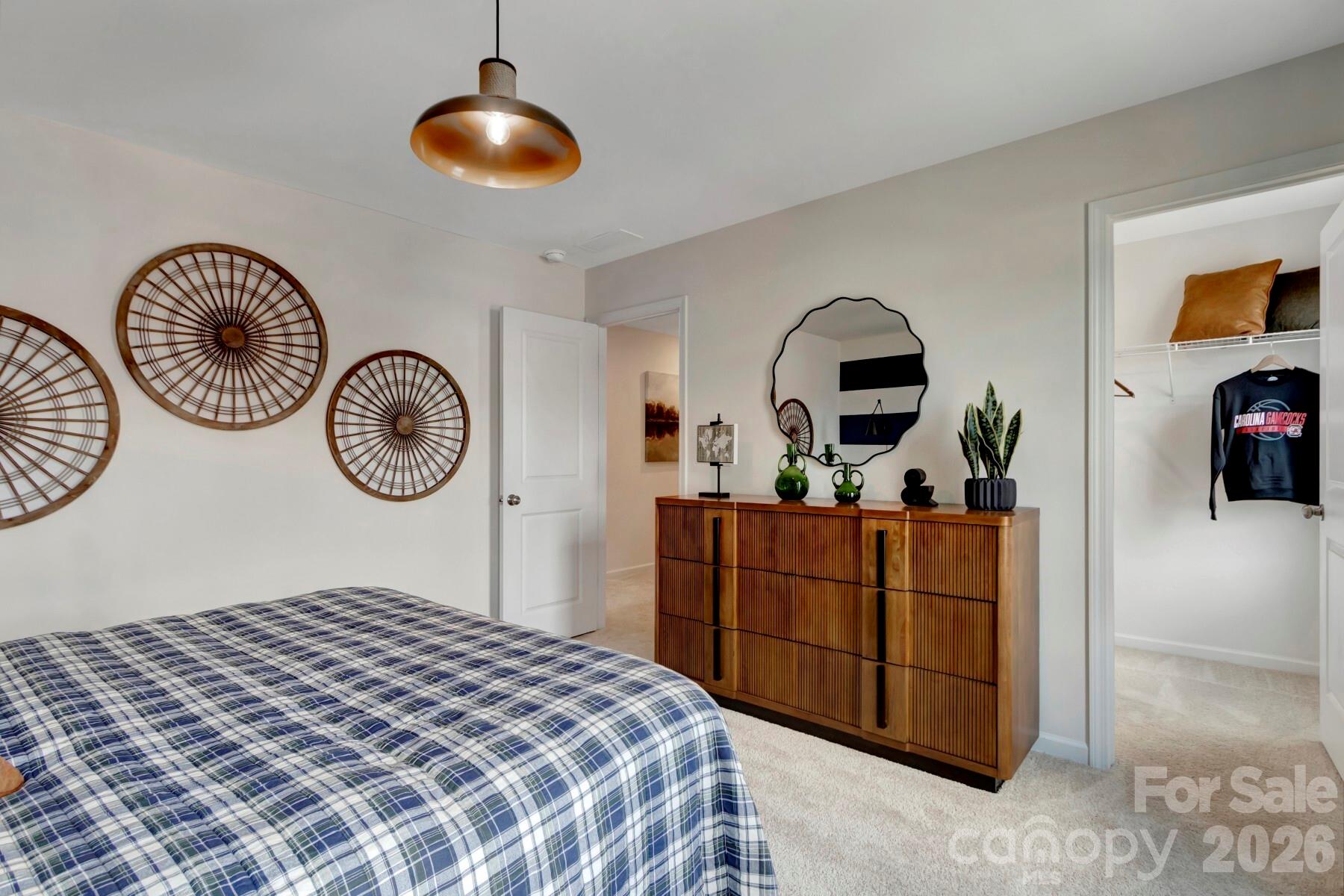 1458 Kate Cecil Way York, SC 29745 - Photo 28 of 40 a bedroom with a bed and a chandelier