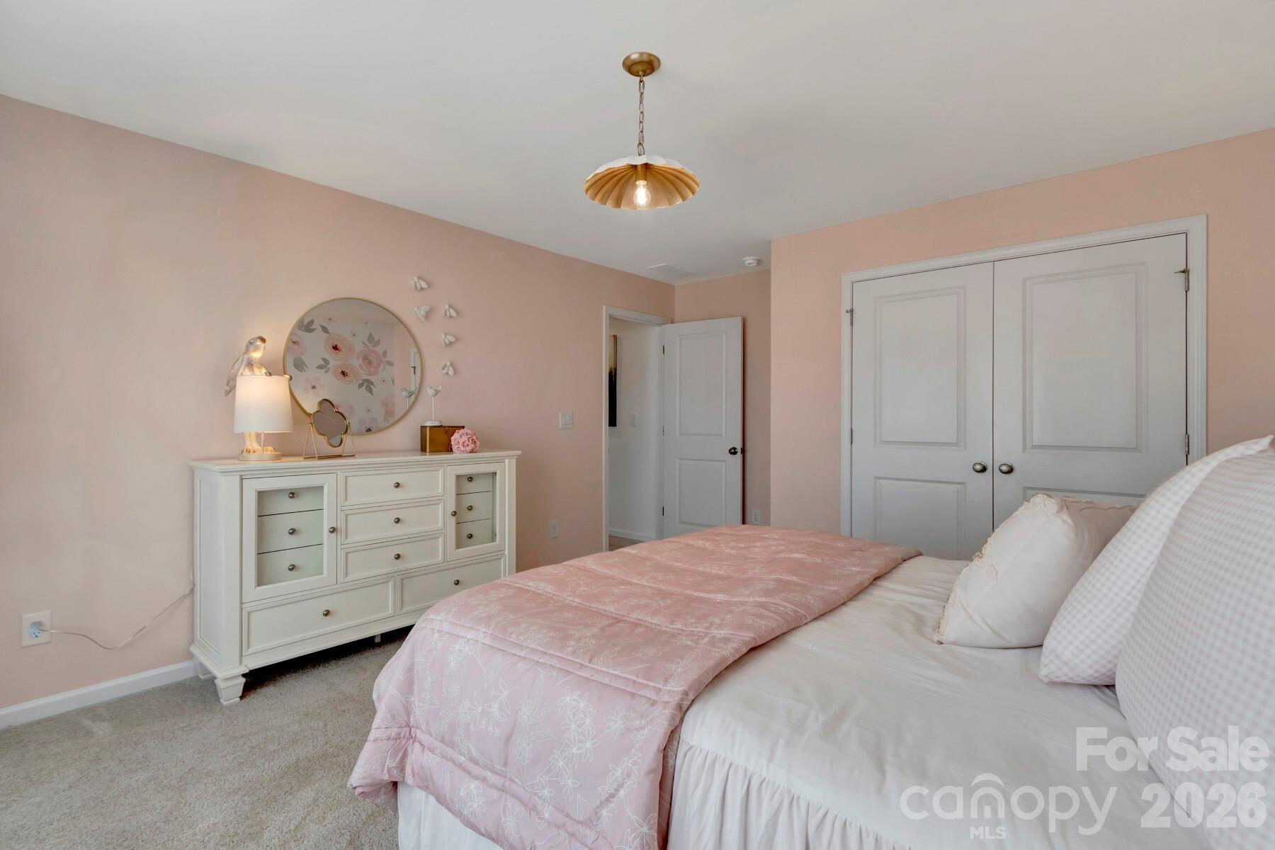 1458 Kate Cecil Way York, SC 29745 - Photo 31 of 40 a bedroom with a bed a chandelier dresser and a window