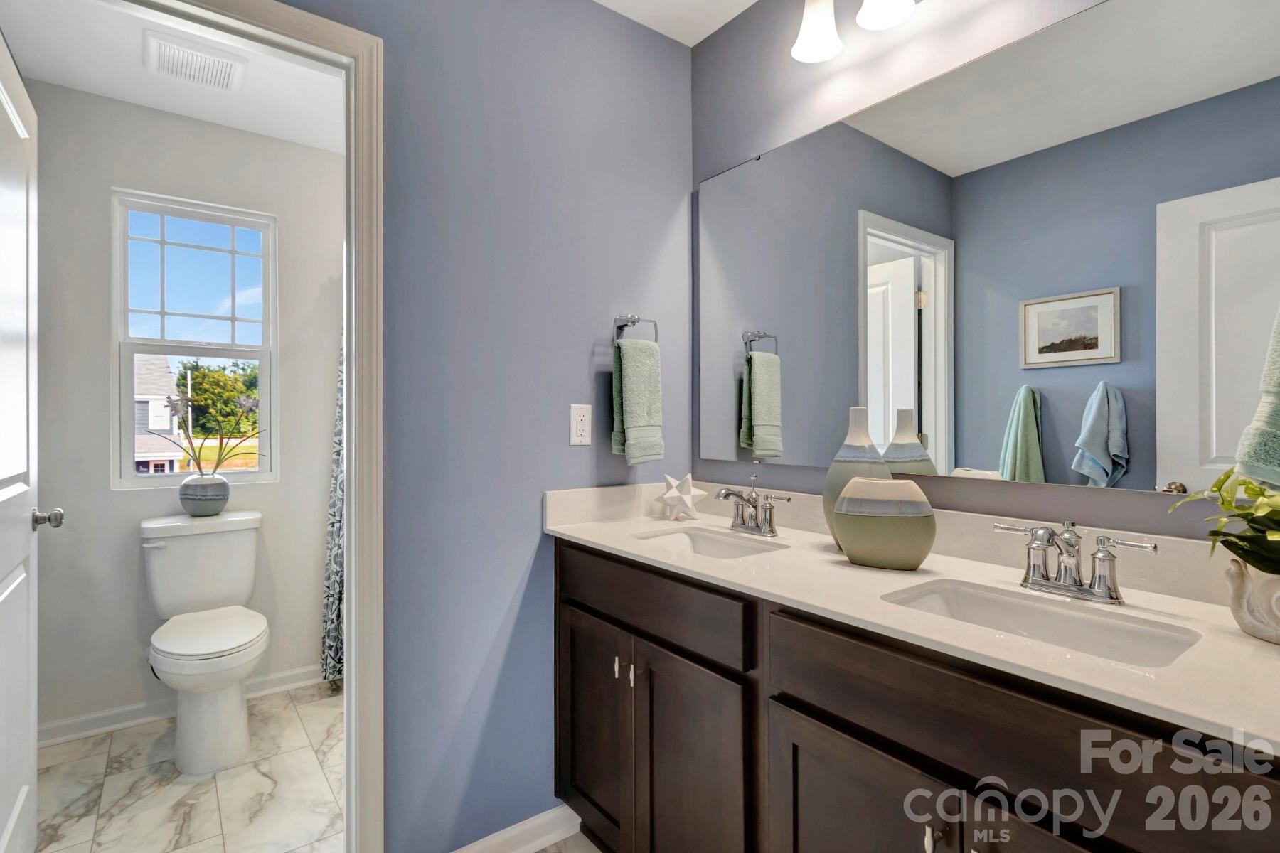 1458 Kate Cecil Way York, SC 29745 - Photo 32 of 40 a bathroom with a granite countertop sink a toilet and a mirror
