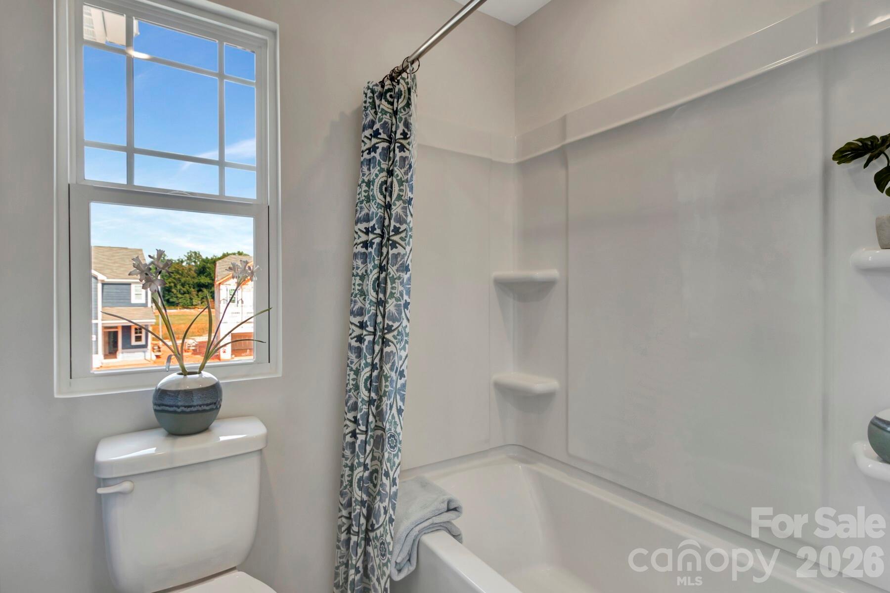 1458 Kate Cecil Way York, SC 29745 - Photo 33 of 40 a bathroom with a bathtub a window and a shower