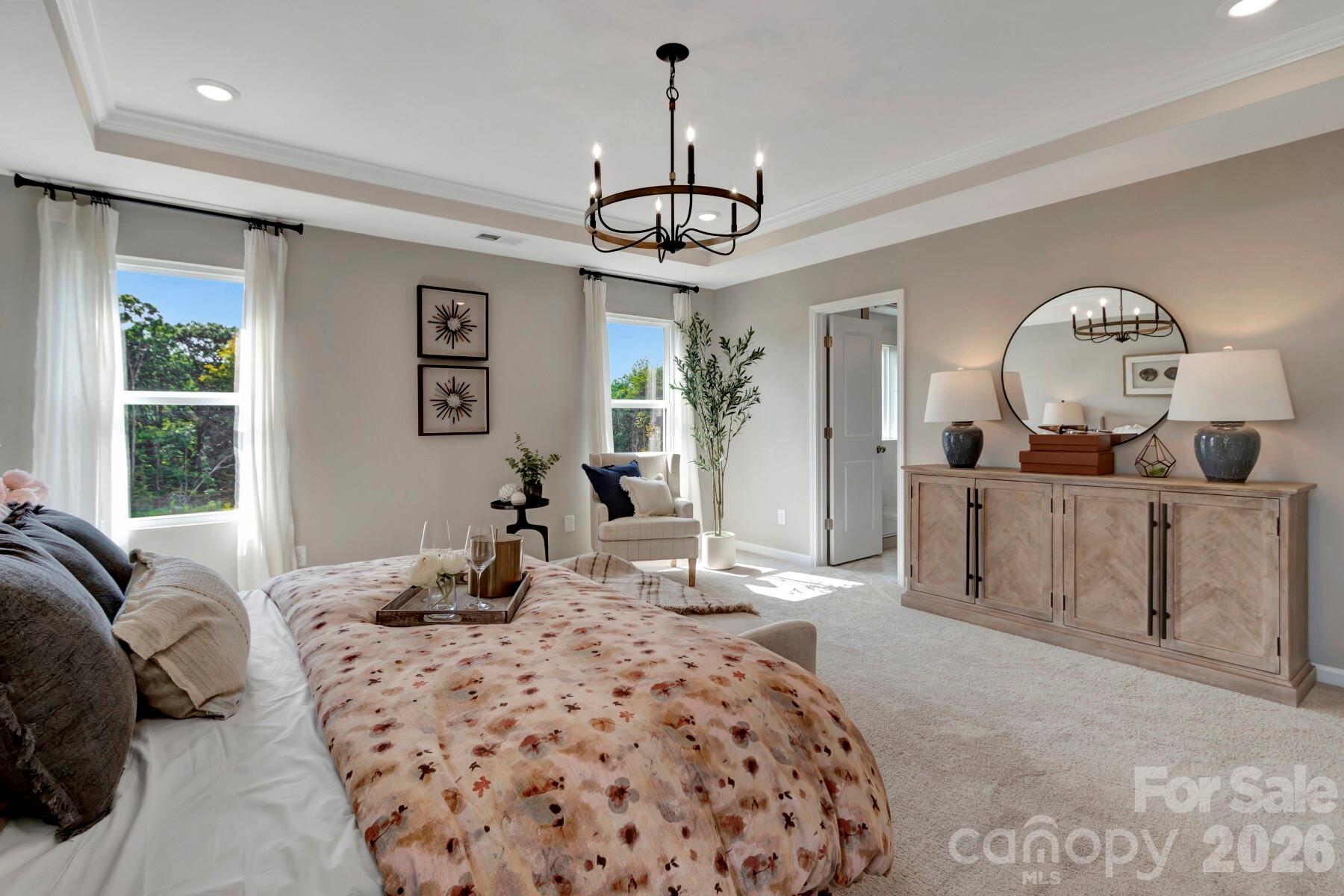 1458 Kate Cecil Way York, SC 29745 - Photo 36 of 40 a bedroom with a bed a chandelier and dresser