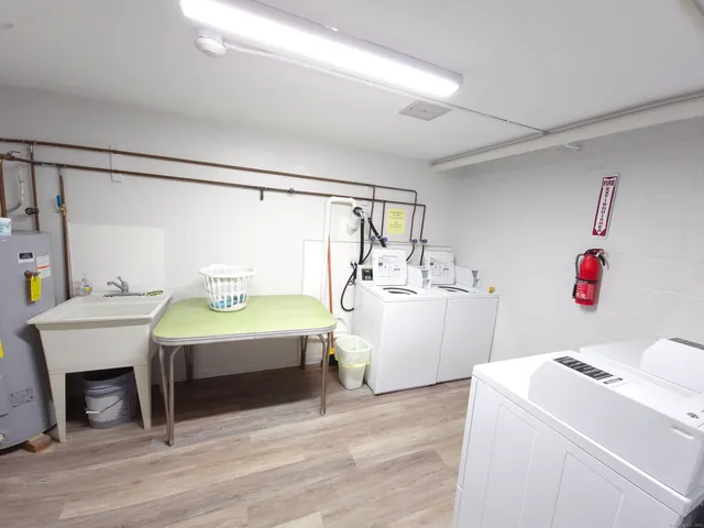 a bedroom with a bed and a table chair