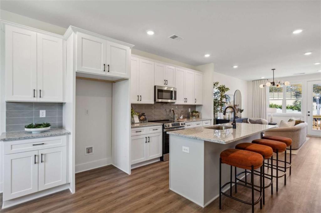 103 Mission Way Atlanta, GA 30315 - Photo 11 of 18 a kitchen with white cabinets and stainless steel appliances