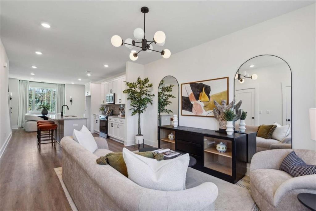 103 Mission Way Atlanta, GA 30315 - Photo 16 of 18 a living room with furniture kitchen view and a chandelier