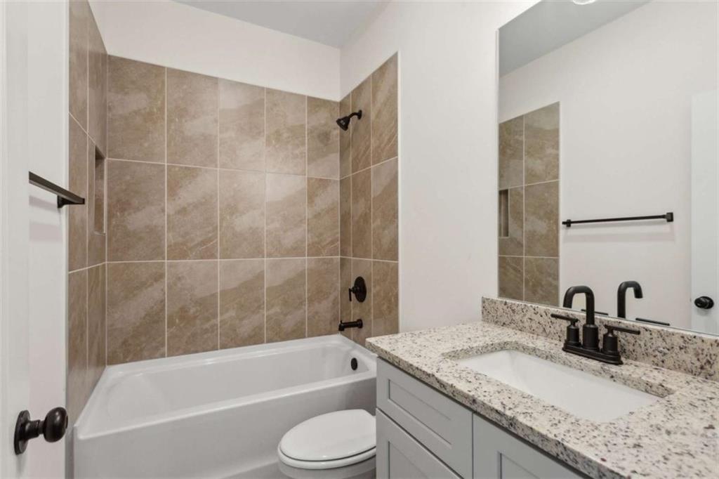 103 Mission Way Atlanta, GA 30315 - Photo 2 of 18 a bathroom with a granite countertop sink a toilet and bathtub