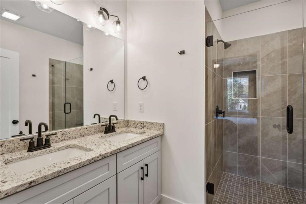 103 Mission Way Atlanta, GA 30315 - Photo 5 of 18 a bathroom with a granite countertop sink a mirror and shower