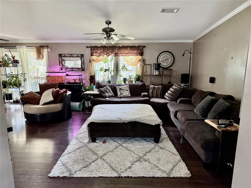 5321 South June Terrace, Unit 74 Homosassa, FL 34446 - Photo 12 of 28 a living room with furniture and a large window