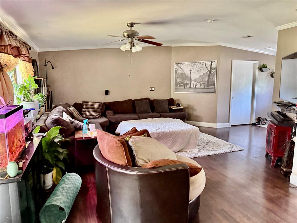 5321 South June Terrace, Unit 74 Homosassa, FL 34446 - Photo 13 of 28 a living room with furniture a flat screen tv and a window