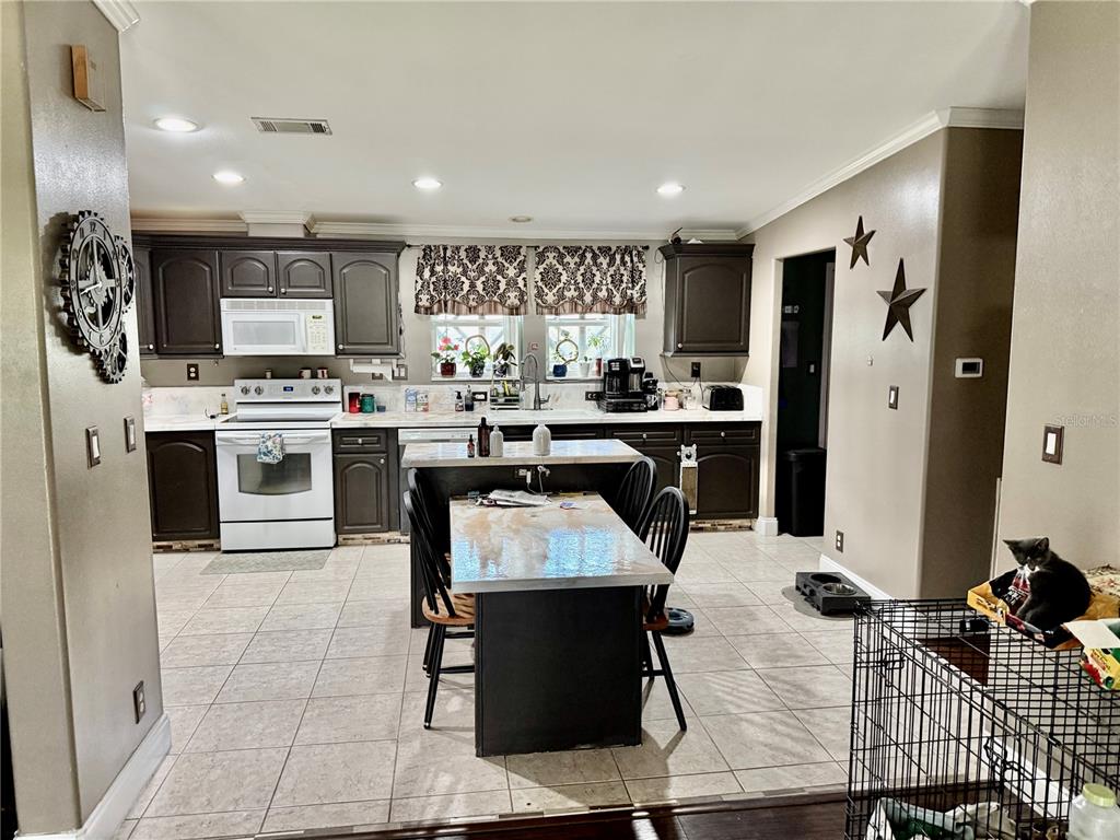 5321 South June Terrace, Unit 74 Homosassa, FL 34446 - Photo 15 of 28 a kitchen with stainless steel appliances kitchen island granite countertop a refrigerator and a stove top oven