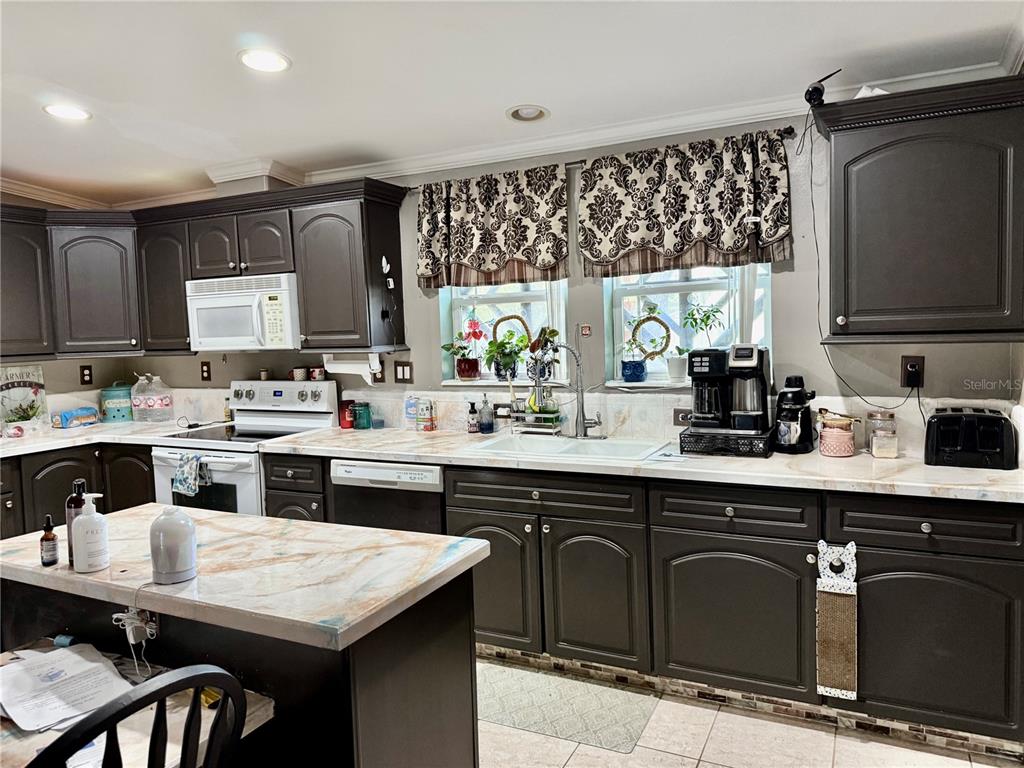 5321 South June Terrace, Unit 74 Homosassa, FL 34446 - Photo 17 of 28 a kitchen with a sink window and cabinets
