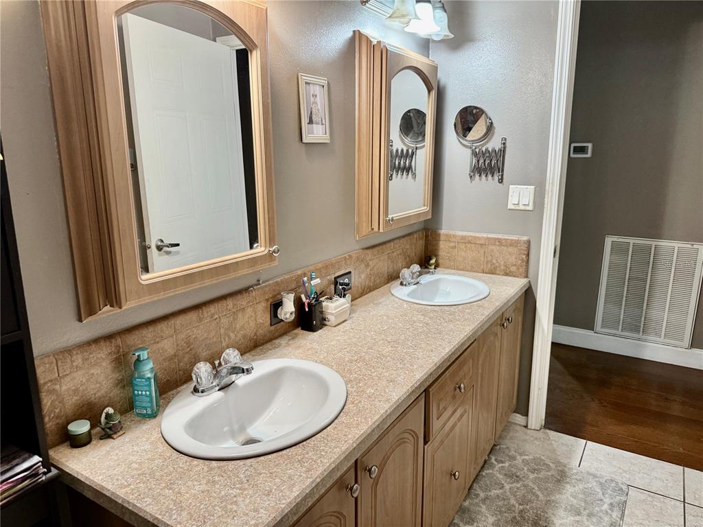 5321 South June Terrace, Unit 74 Homosassa, FL 34446 - Photo 21 of 28 a bathroom with double vanity sinks and a mirror