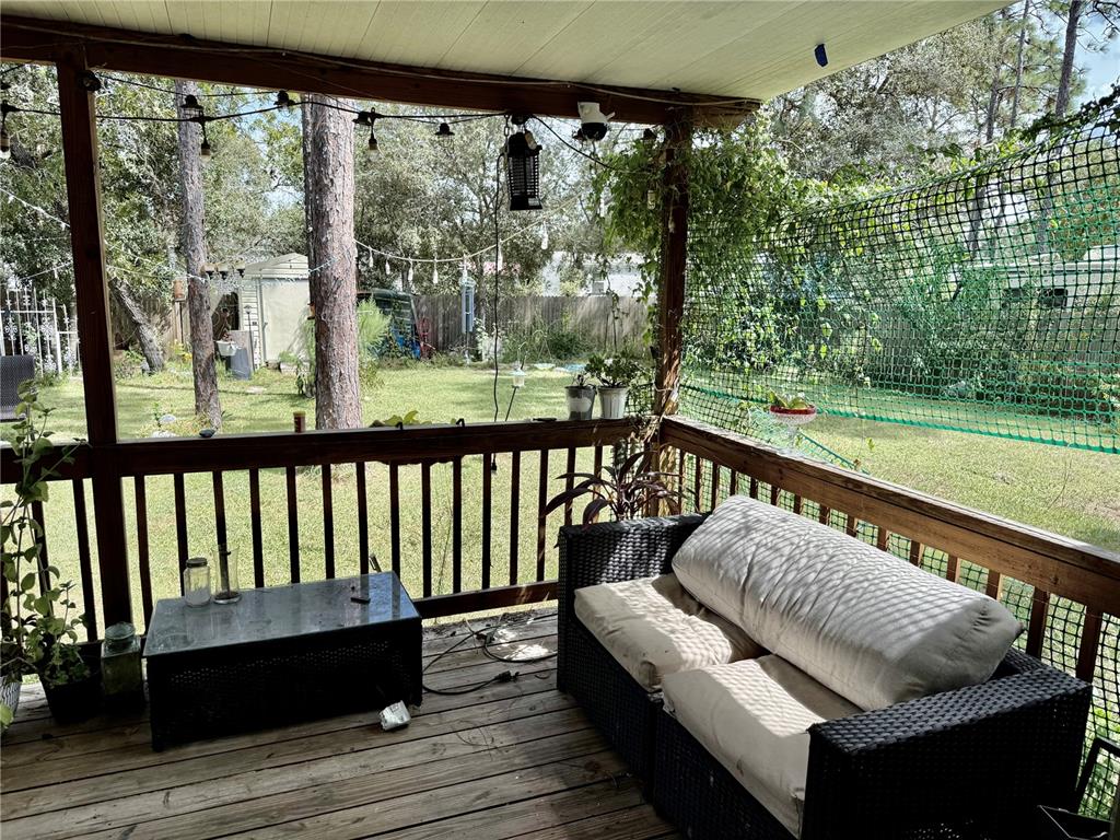 5321 South June Terrace, Unit 74 Homosassa, FL 34446 - Photo 25 of 28 a balcony with wooden floor and outdoor seating