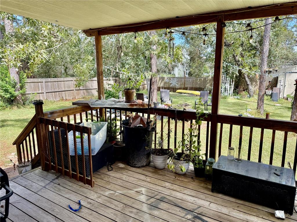 5321 South June Terrace, Unit 74 Homosassa, FL 34446 - Photo 26 of 28 a view of a wooden deck with chairs