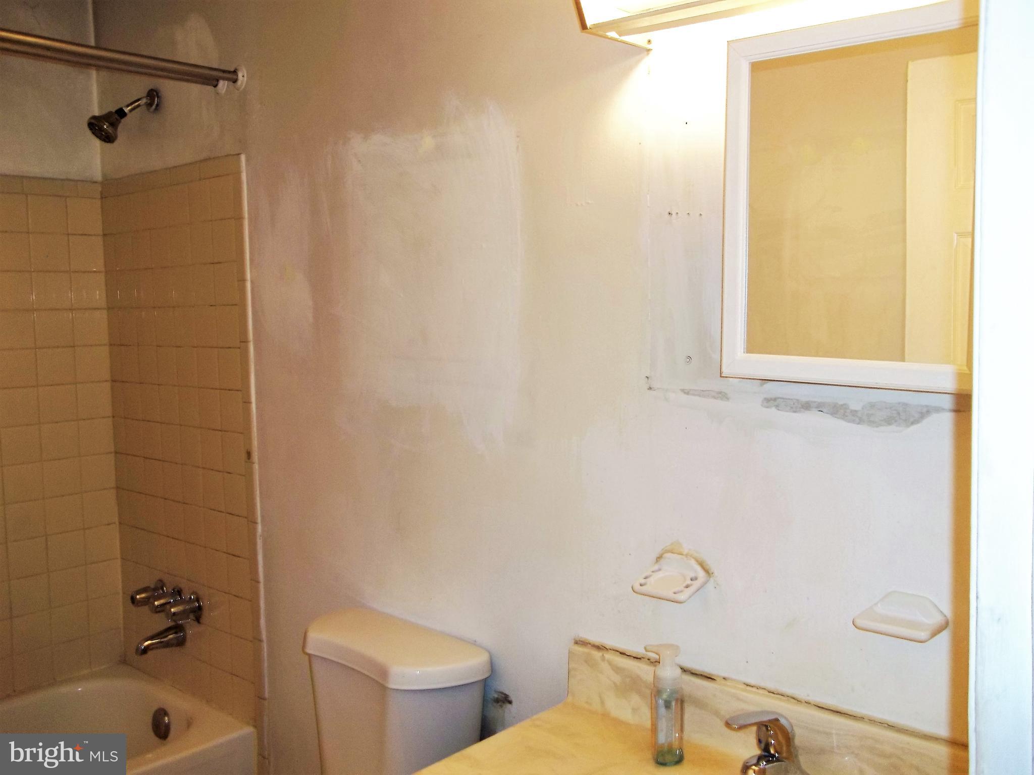 1726 Crimson Tree Way, Unit 18D Edgewood, MD 21040 - Photo 7 of 8 a bathroom with a sink a toilet and shower