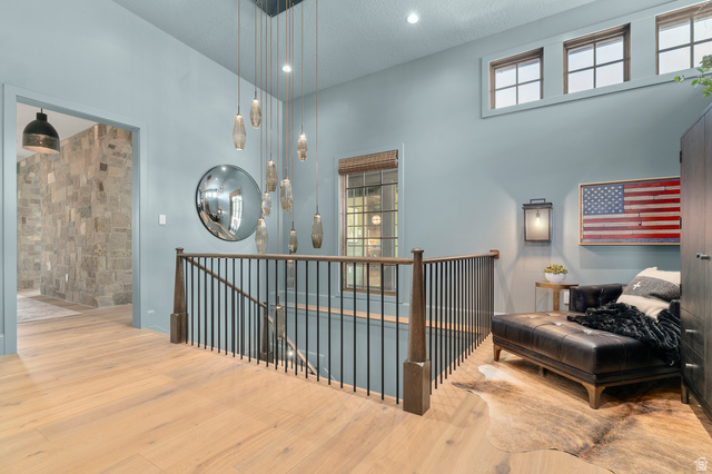2192 East Outlaw Road Kamas, UT 84036 - Photo 36 of 80 Hardwood flooring throughout, custom chandelier, three transom windows, wrought iron stair railing, and a stone accent wall