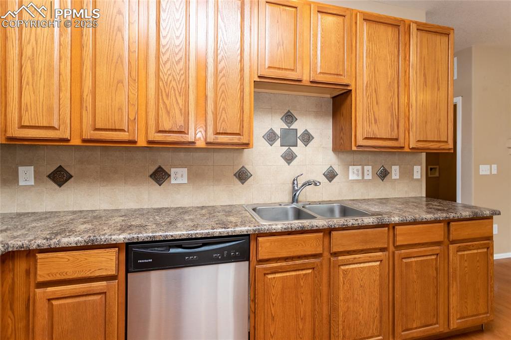 4829 Harrier Ridge Drive Colorado Springs, CO 80916 - Photo 13 of 50 a kitchen with granite countertop cabinets and window