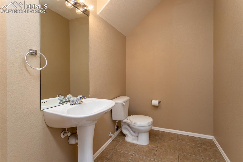 4829 Harrier Ridge Drive Colorado Springs, CO 80916 - Photo 18 of 50 a bathroom with a sink toilet and mirror