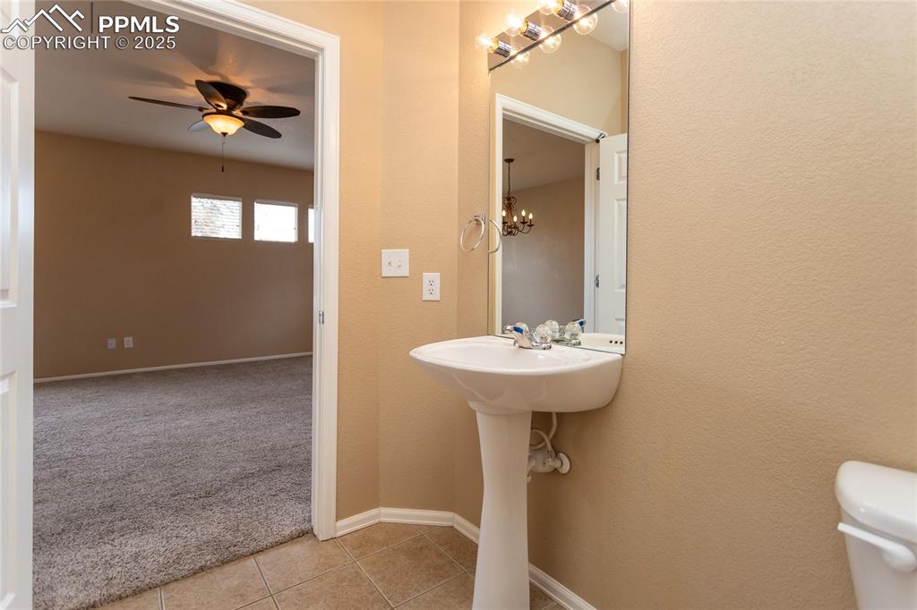 4829 Harrier Ridge Drive Colorado Springs, CO 80916 - Photo 19 of 50 a bathroom with a sink toilet and mirror