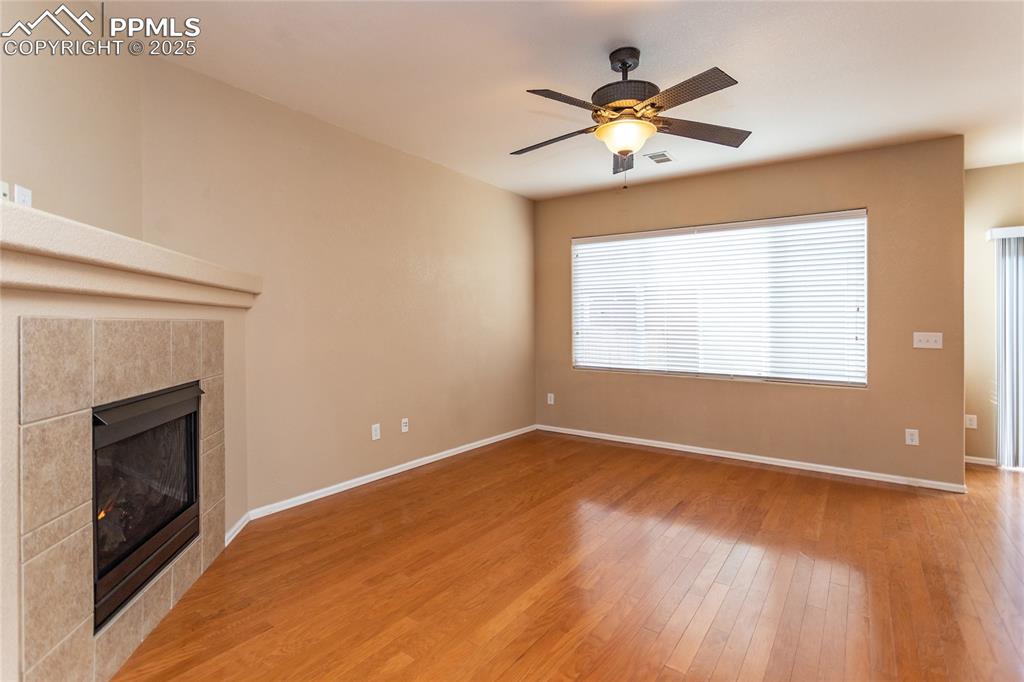 4829 Harrier Ridge Drive Colorado Springs, CO 80916 - Photo 21 of 50 a view of an empty room with chandelier fan and fire place