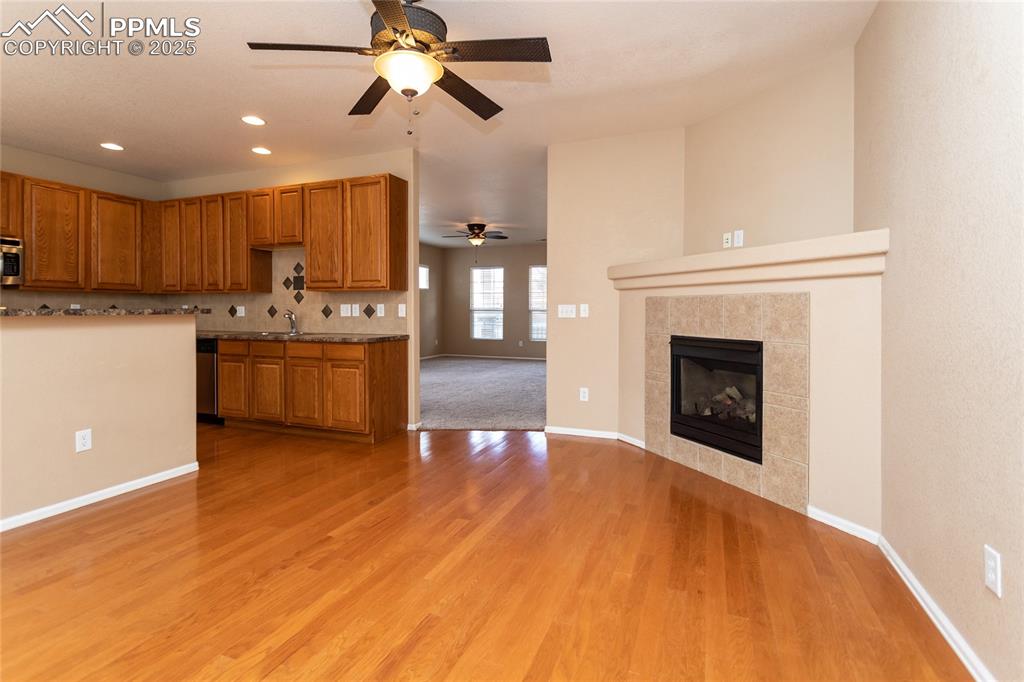 4829 Harrier Ridge Drive Colorado Springs, CO 80916 - Photo 22 of 50 a view of a kitchen with a stove cabinets and wooden floor
