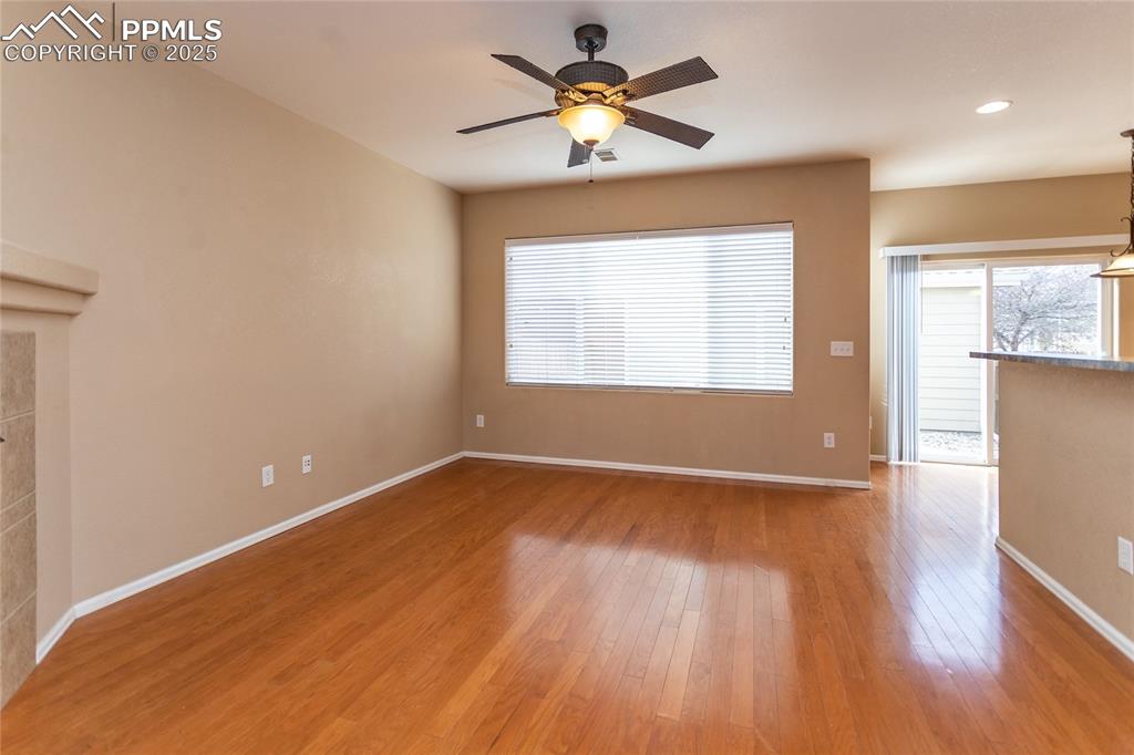 4829 Harrier Ridge Drive Colorado Springs, CO 80916 - Photo 24 of 50 a view of an empty room with a window and wooden floor